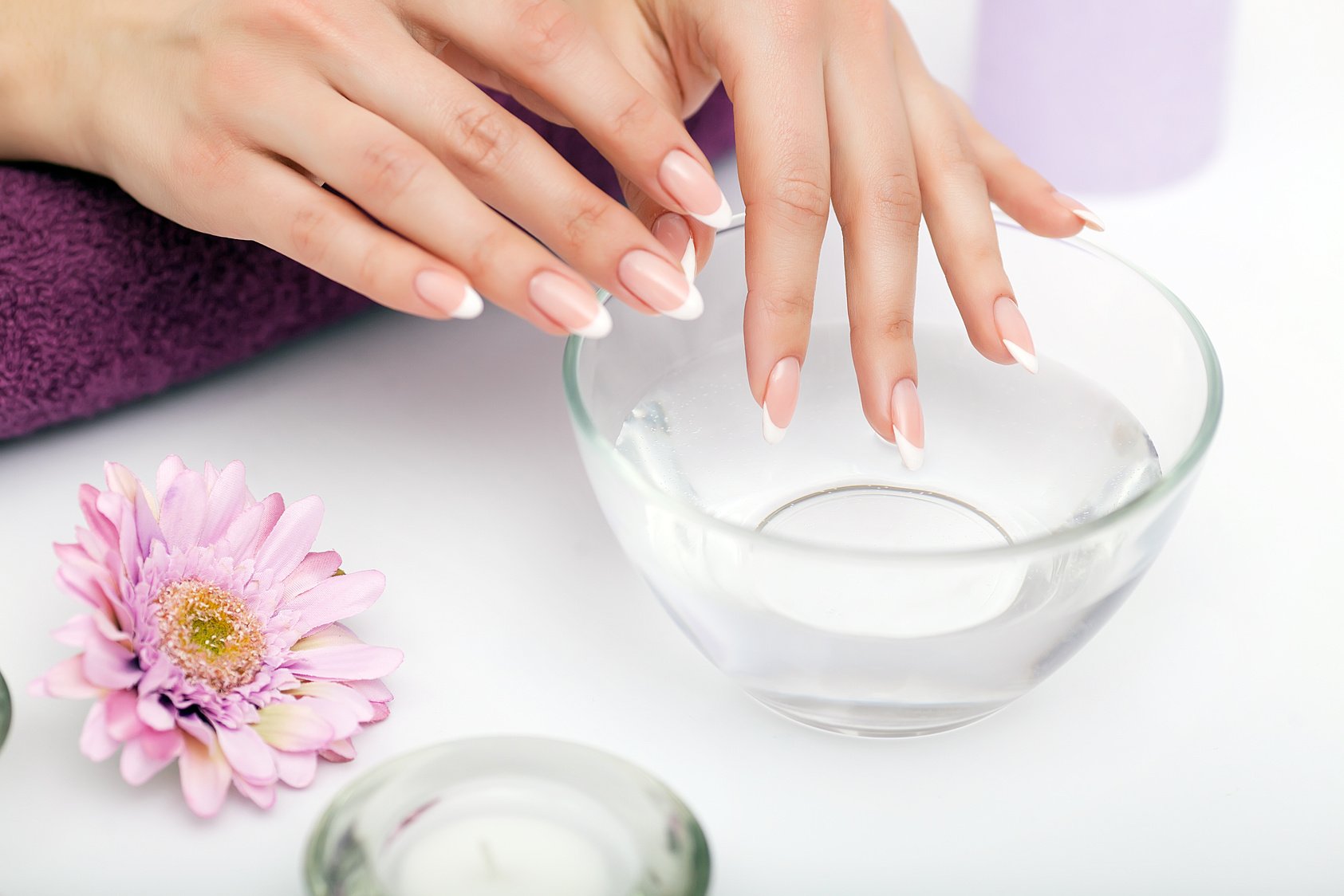 Woman Dipping Her Hands in Water for a Hand Scrub